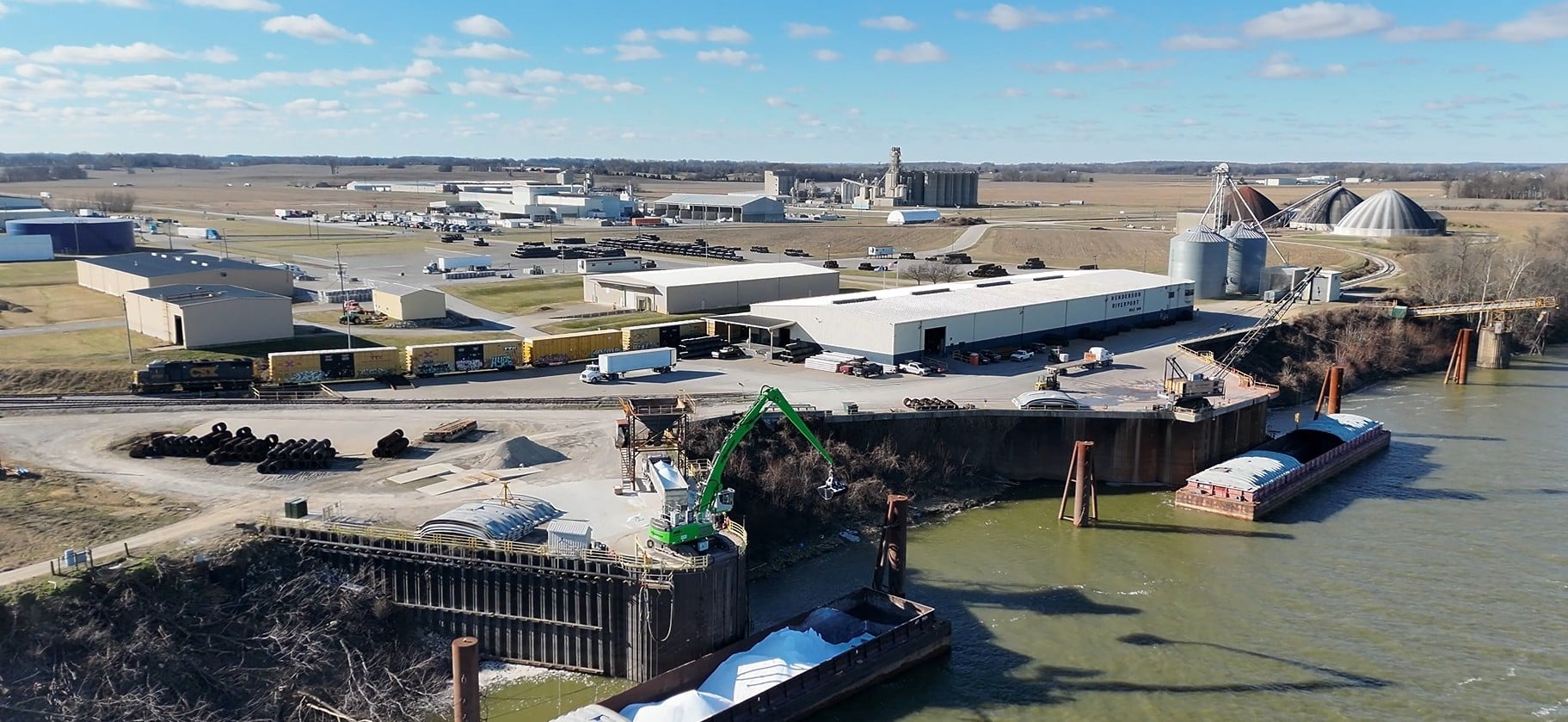 Photograph of acrane and material handler unloading.